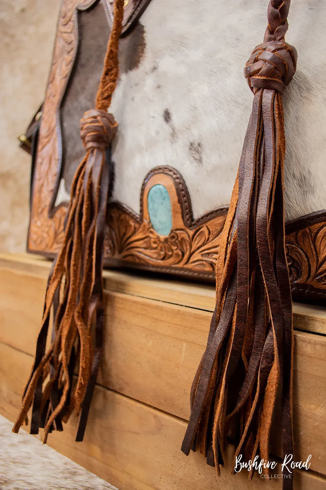 Brown Leather Duffel Bag With Black Sides, Brass Hardware, Hanging From A Hook — Bushfire Road Collective in Mareeba ,QLD