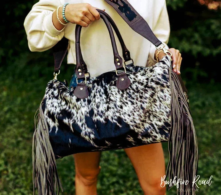 Woman Holding a Cowhide Bag With Dark Blue and White Pattern — Bushfire Road Collective in Mareeba, QLD