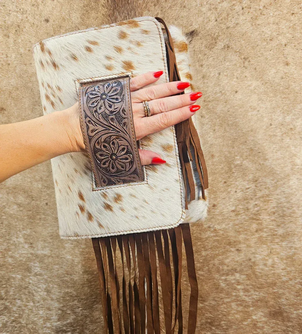 Brown Leather Clutch With Blue Floral Design, Sitting On A Cowhide Rug — Bushfire Road Collective in Mareeba ,QLD