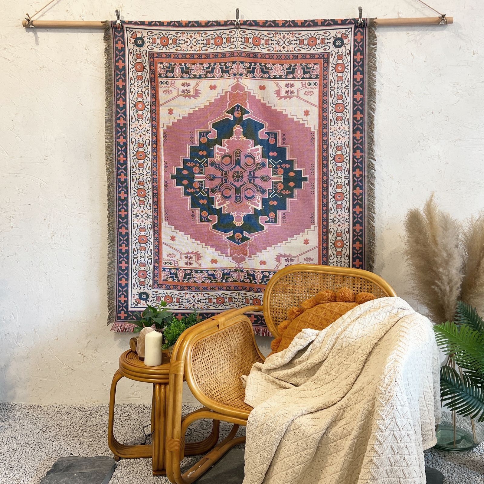 Woven Rug Wall Hanging With Pink, Blue, And Cream Hues Above A Wicker Chair With A Throw Blanket — Bushfire Road Collective in Mareeba ,QLD