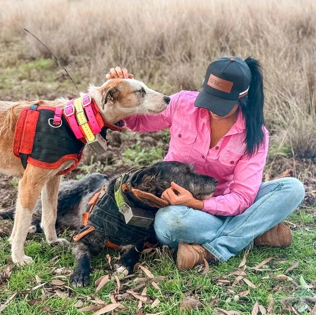 Man In Sunglasses And Cap Smiles Outside, Vehicles In The Background — Bushfire Road Collective in Mareeba ,QLD