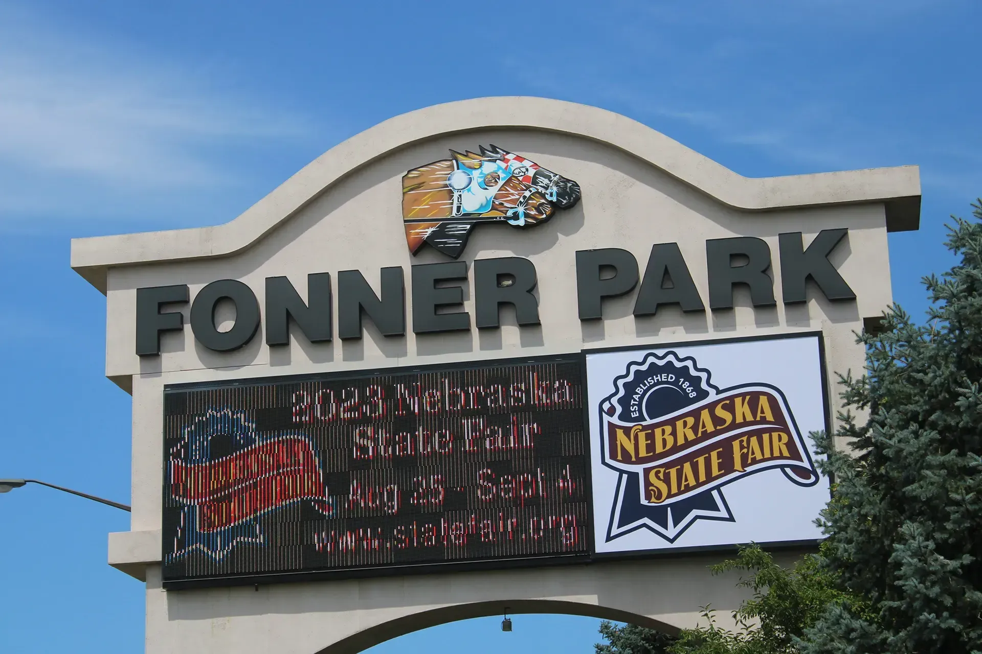 Fonner Park entrance sign with Nebraska State Fair banner against a blue sky
