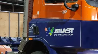 Orange and blue Atlas waste truck with logo 