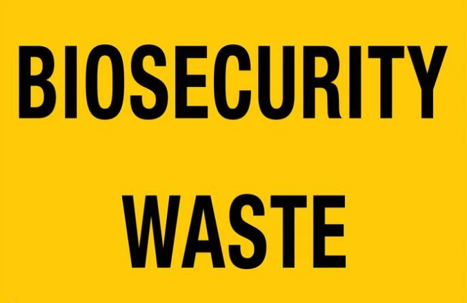 Yellow sign with black text: BIOSECURITY WASTE.