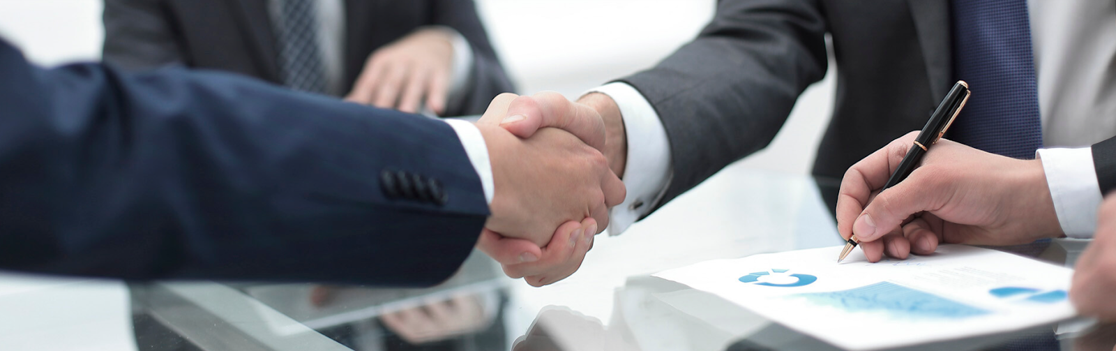 Man in orange shirt gives thumbs up from truck cab. Orange and blue truck has logo.