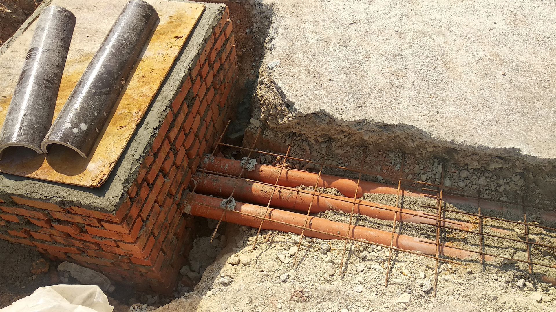 Installation of underground pipe supporting structures to prevent soil collapse.