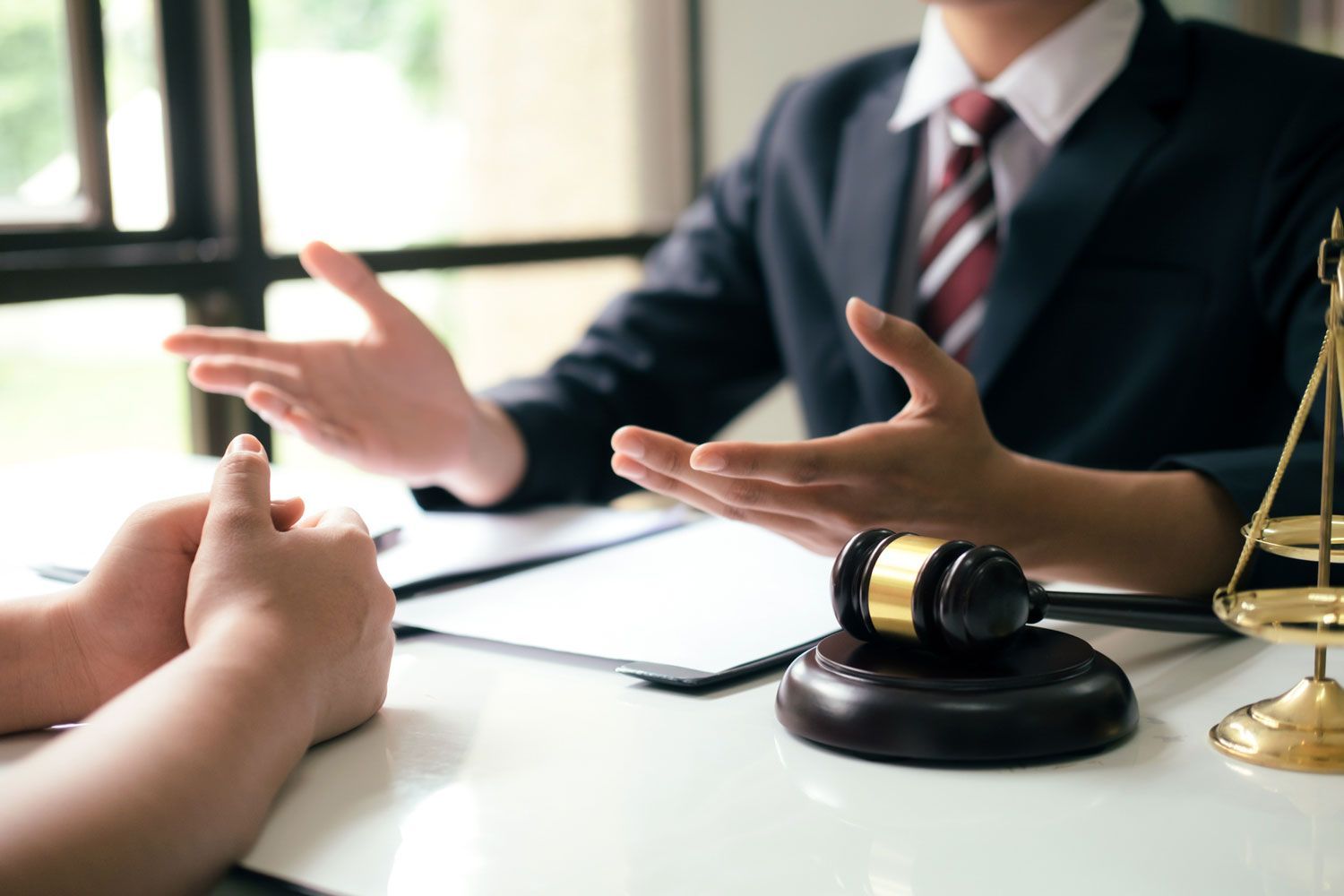 A lawyer is sitting at a table talking to a client.