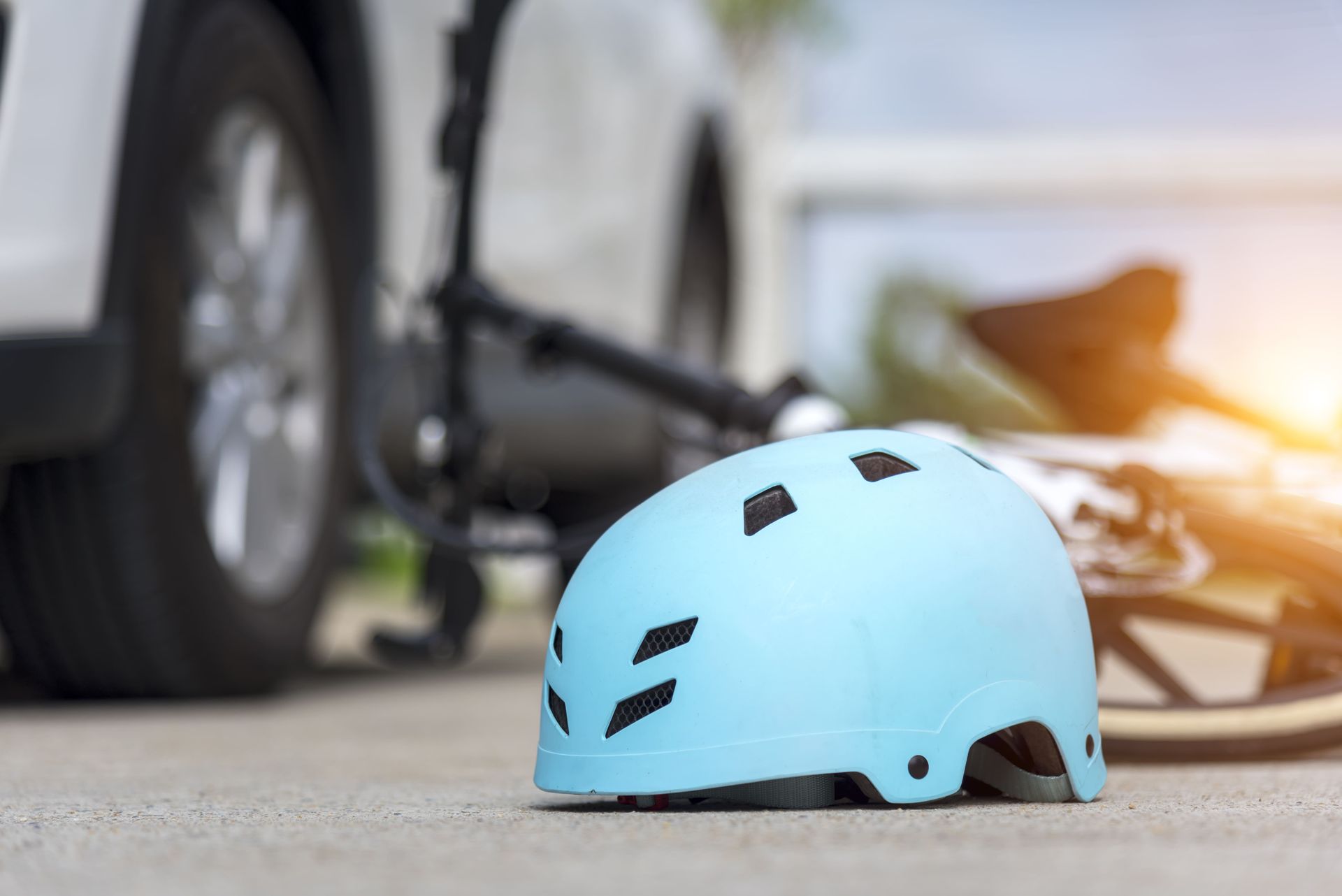 A helmet is laying on the ground next to a motorcycle. A helmet is laying on the ground next to a motorcycle.