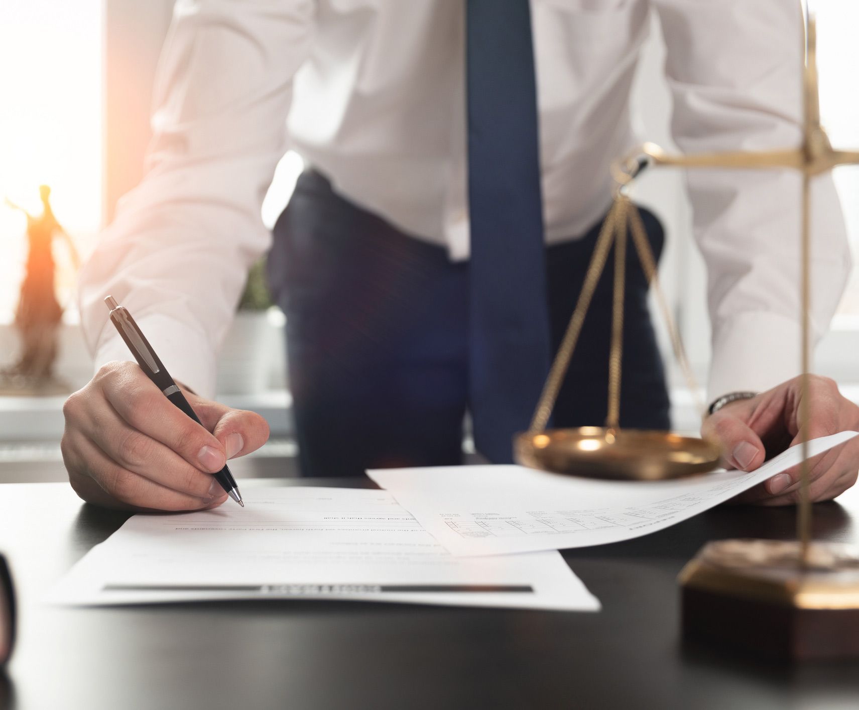 Attorney with Pen Writing on a Paper Attorney with Pen Writing on a Paper