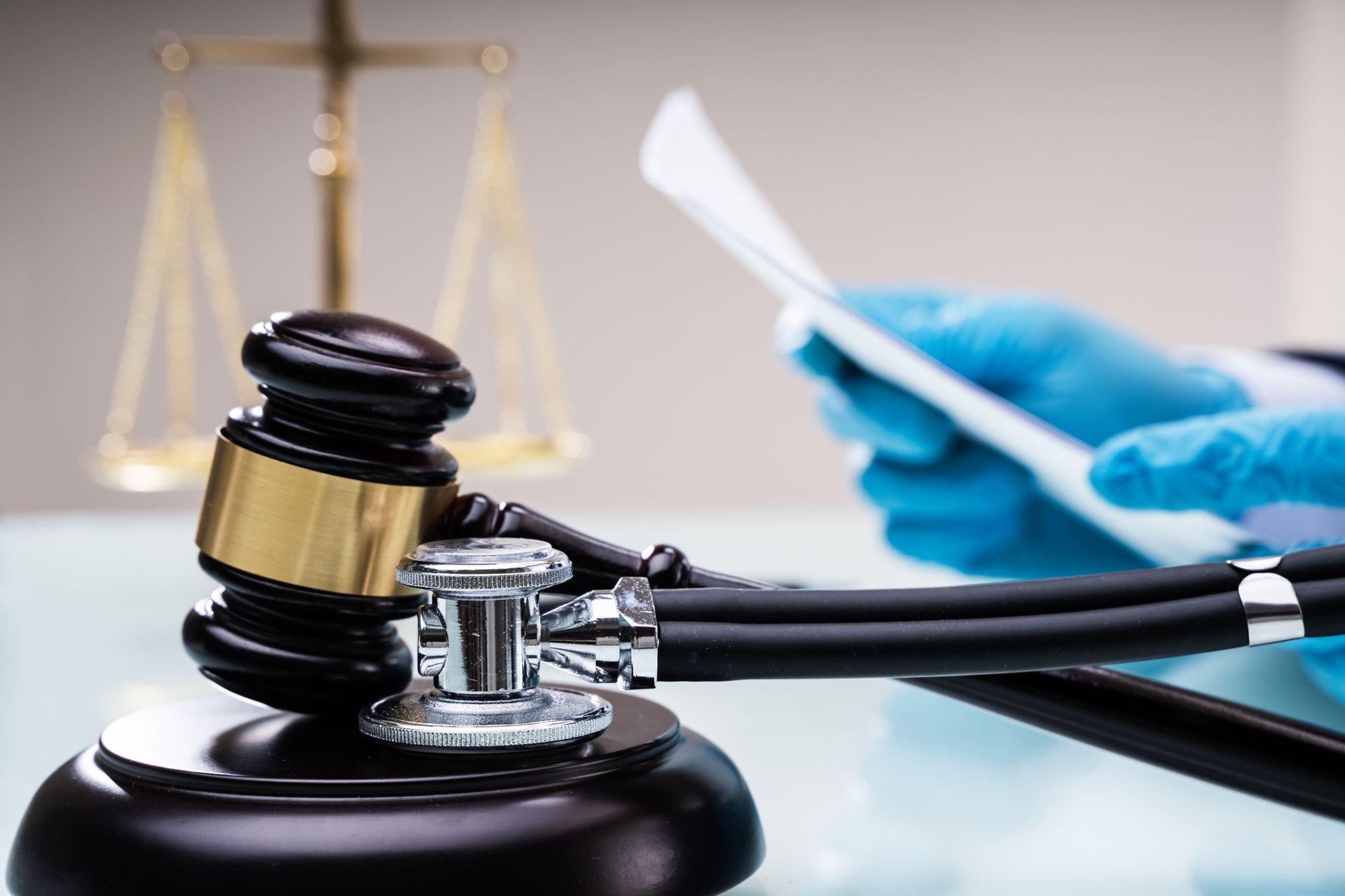A judge 's gavel with a stethoscope attached to it.