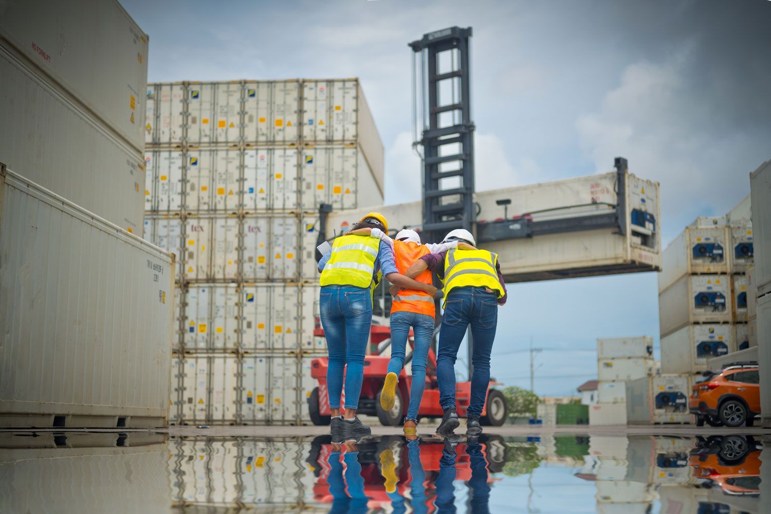 A group of construction workers are working on a forklift in a warehouse.