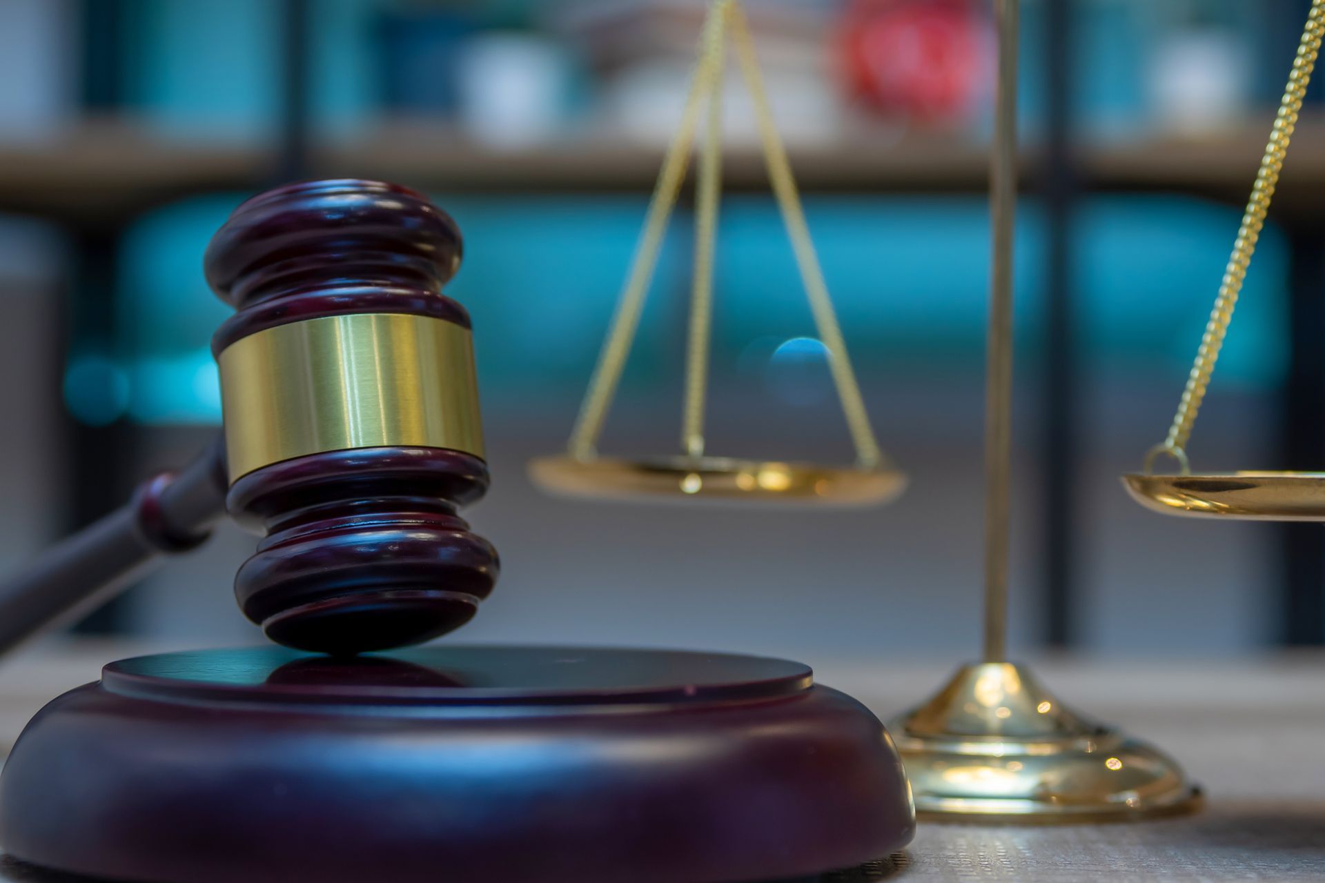 A judge 's gavel and scales of justice are on a table.