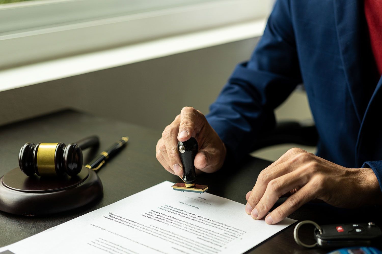 A man is stamping a document on a table.