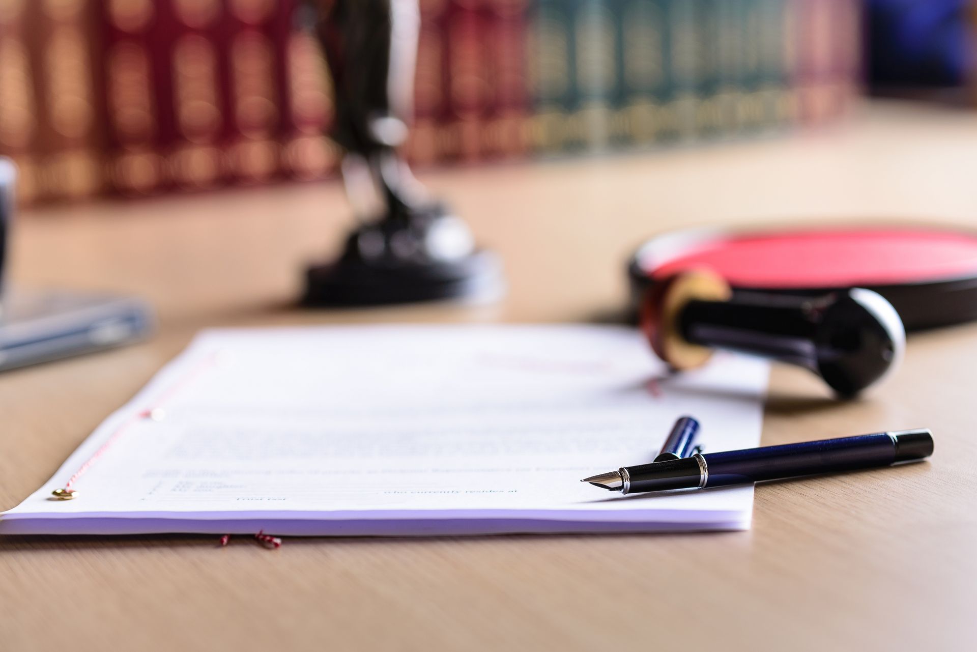 A pen is sitting on top of a piece of paper on a table.