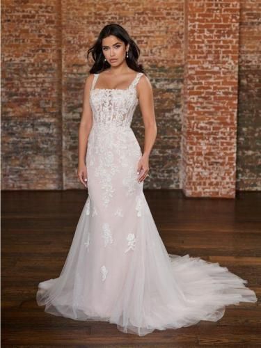 Woman in white lace wedding dress, square neckline, mermaid skirt, and long train.