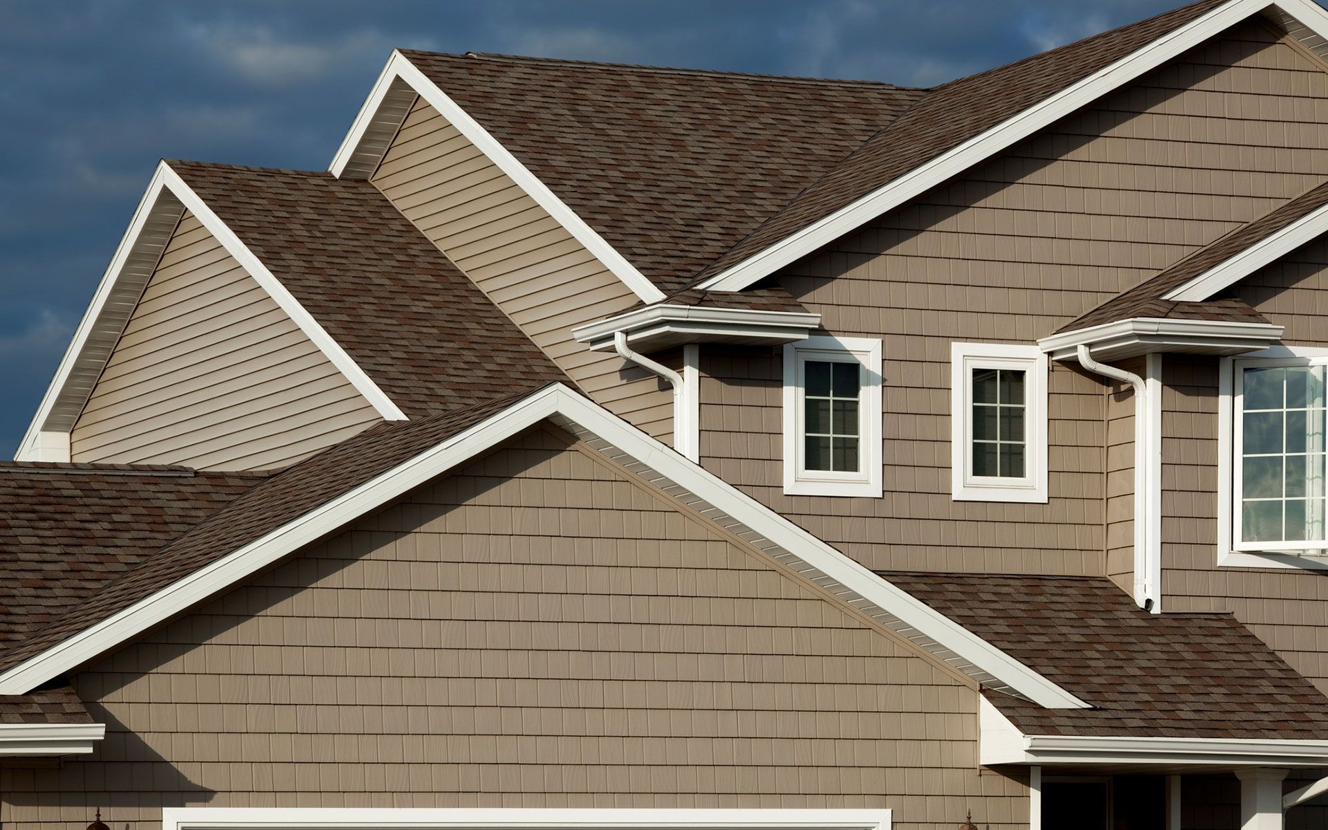 A house with a brown roof and white trim