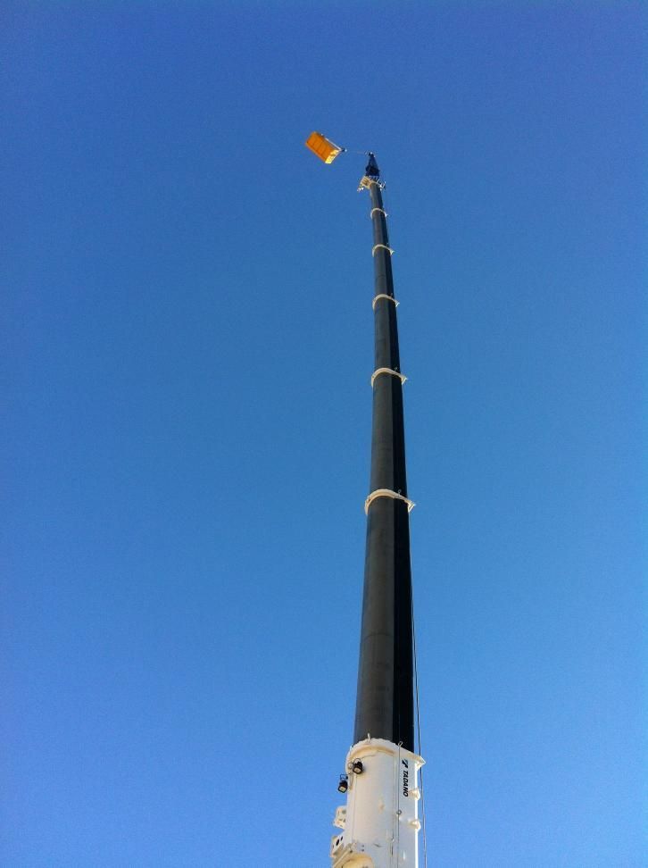 Very Tall Tower With a Yellow Flag on Top of It — Barkly Hire in Ryan, QLD