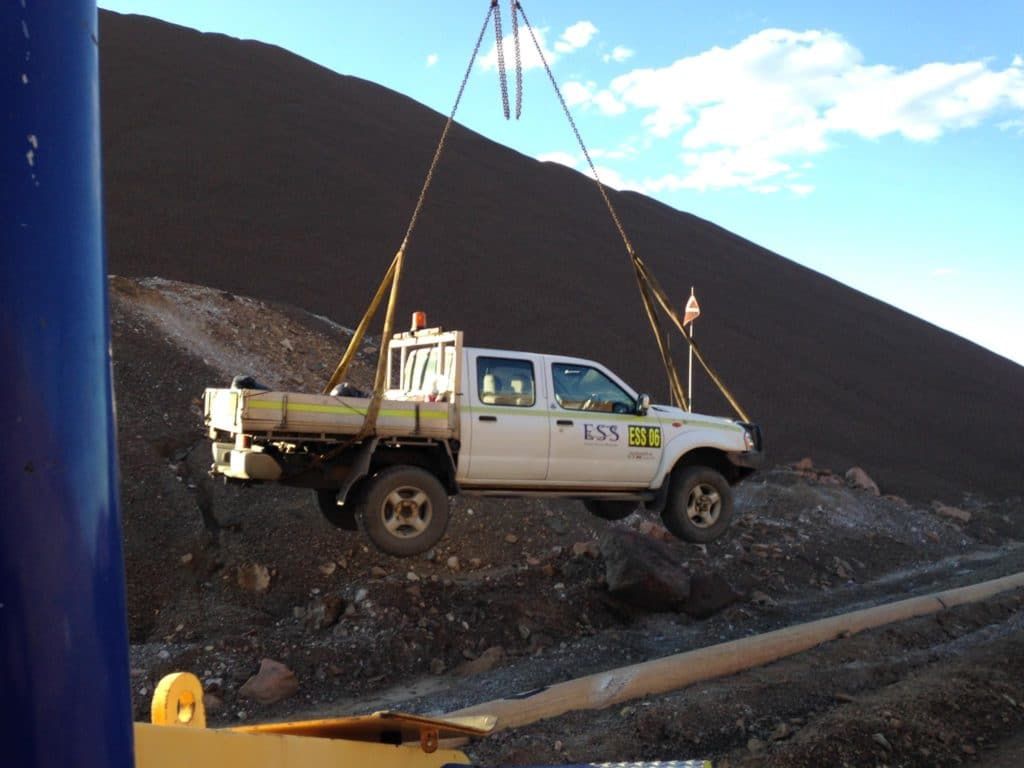 White Truck is Being Lifted by a Crane With the Letters Lcm on the Side — Barkly Hire in Ryan, QLD