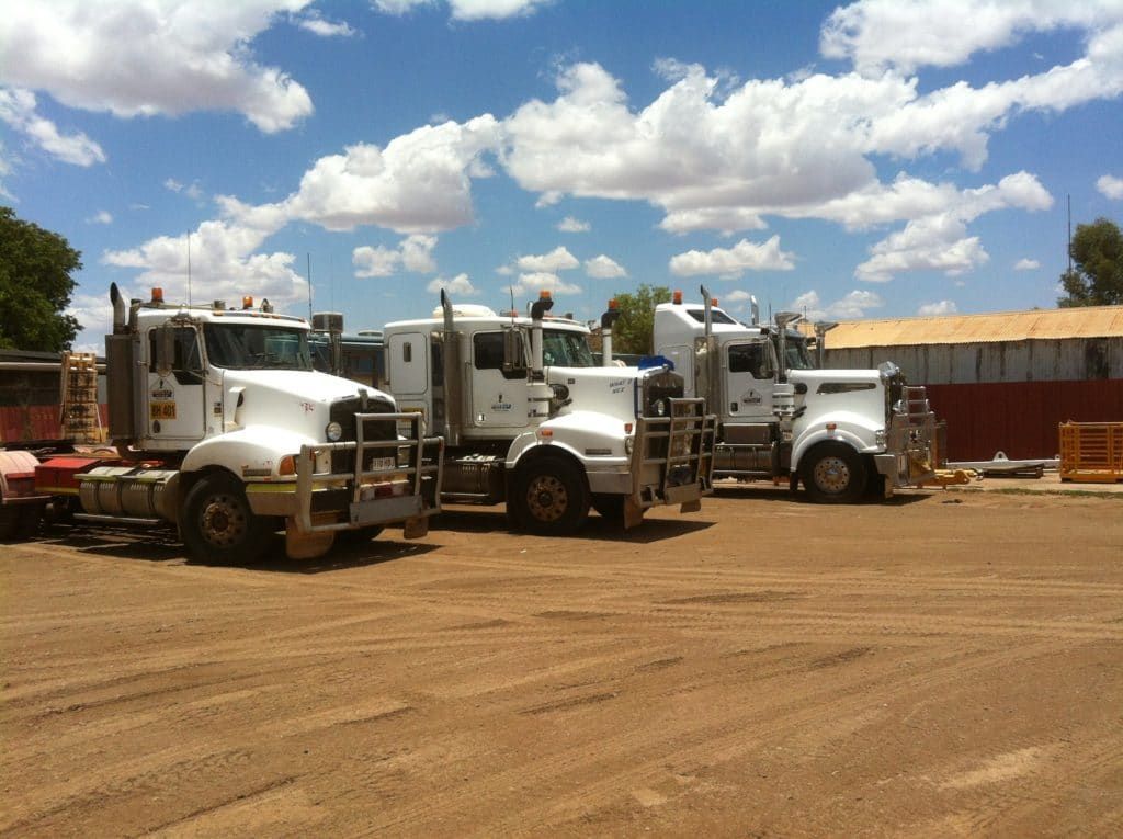 Row of Semi Trucks Are Parked in a Dirt — Barkly Hire in Ryan, QLD