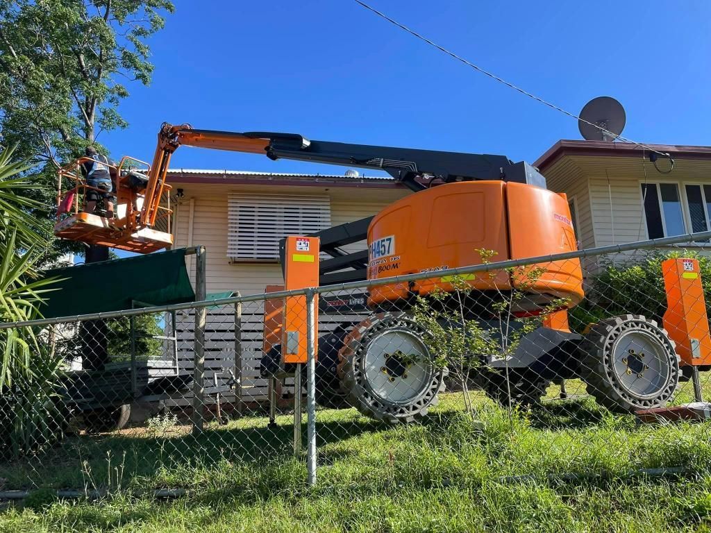 Large Orange Crane is Parked in Front of a House — Barkly Hire in Ryan, QLD