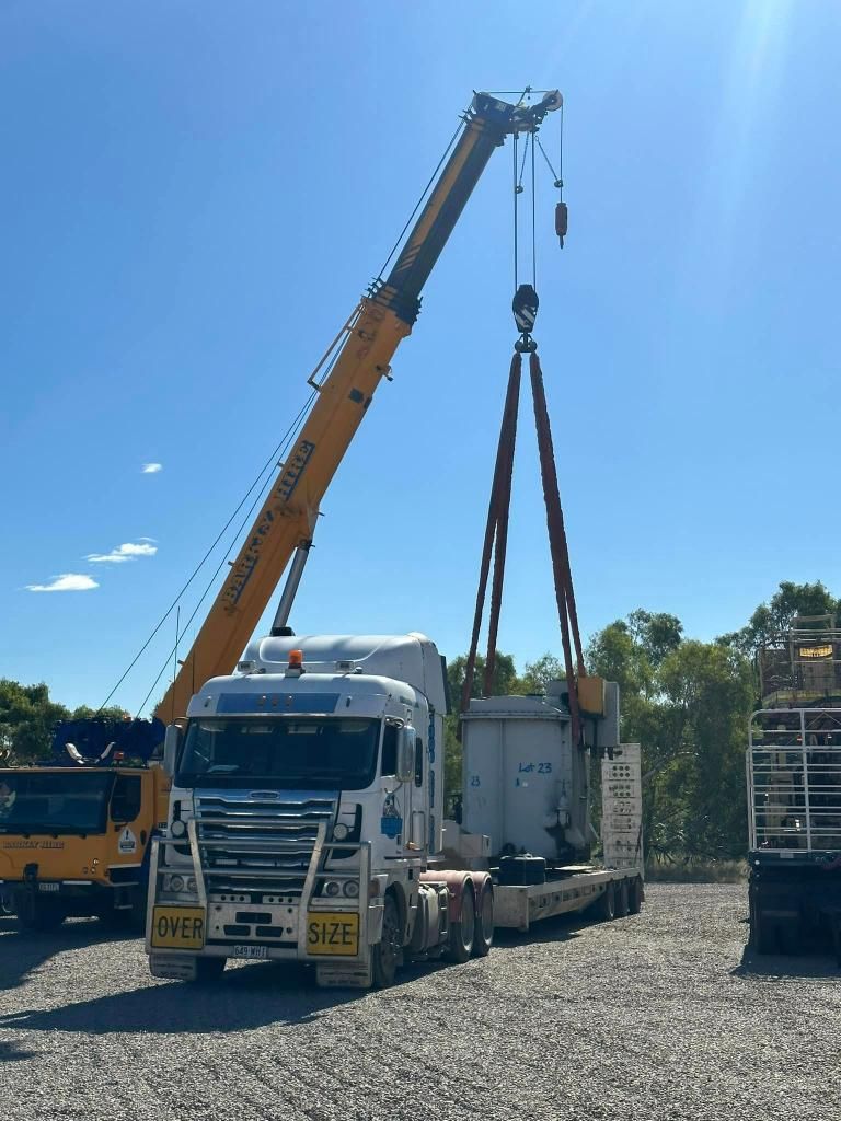 Truck is Being Lifted by a Crane in a Gravel Lot — Barkly Hire in Ryan, QLD