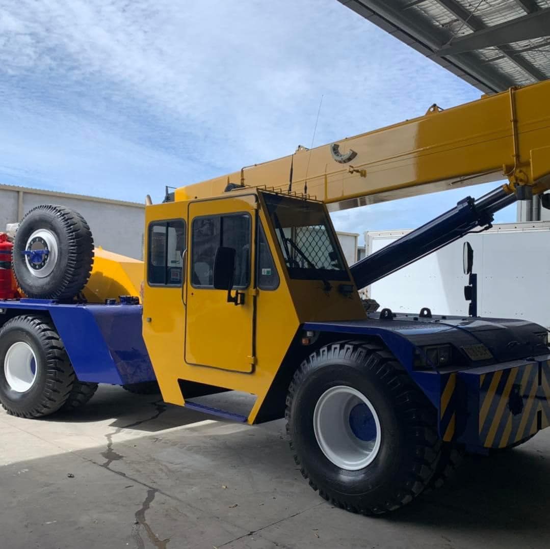 Yellow and Blue Truck With a Crane Attached to It — Barkly Hire in Ryan, QLD