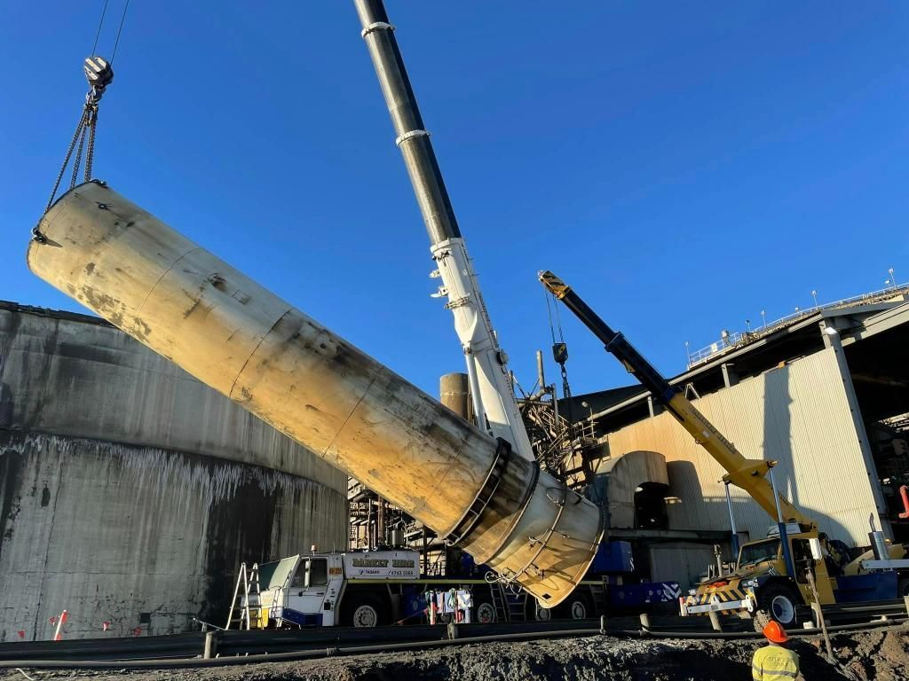 Large Pipe is Being Lifted by a Crane in Front of a Building — Barkly Hire in Ryan, QLD