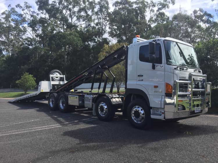 White Tow Truck With a Flatbed Trailer Attached to It is Parked in a Parking Lot — Barkly Hire in Ryan, QLD