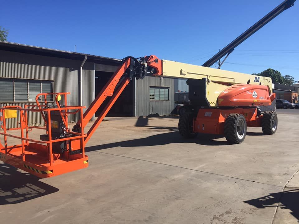 Large Orange Lift is Parked in Front of a Building — Barkly Hire in Ryan, QLD