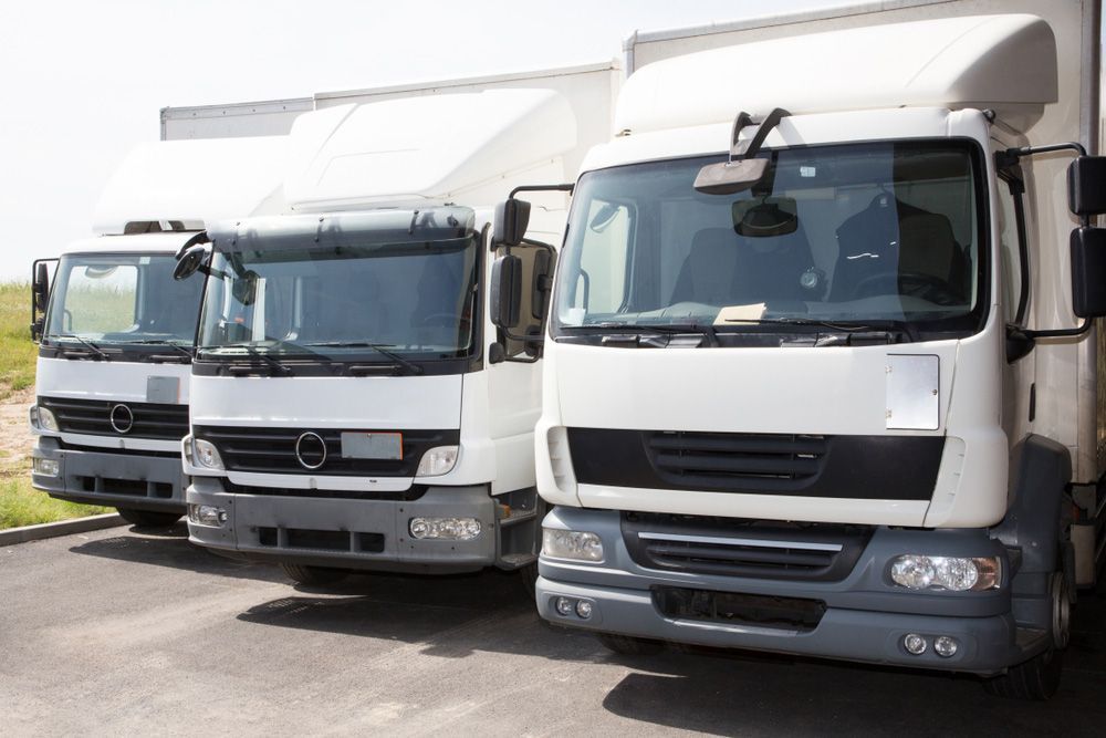 Three White Trucks Are Parked Next to Each Other in a Parking Lot — Barkly Hire in Ryan, QLD