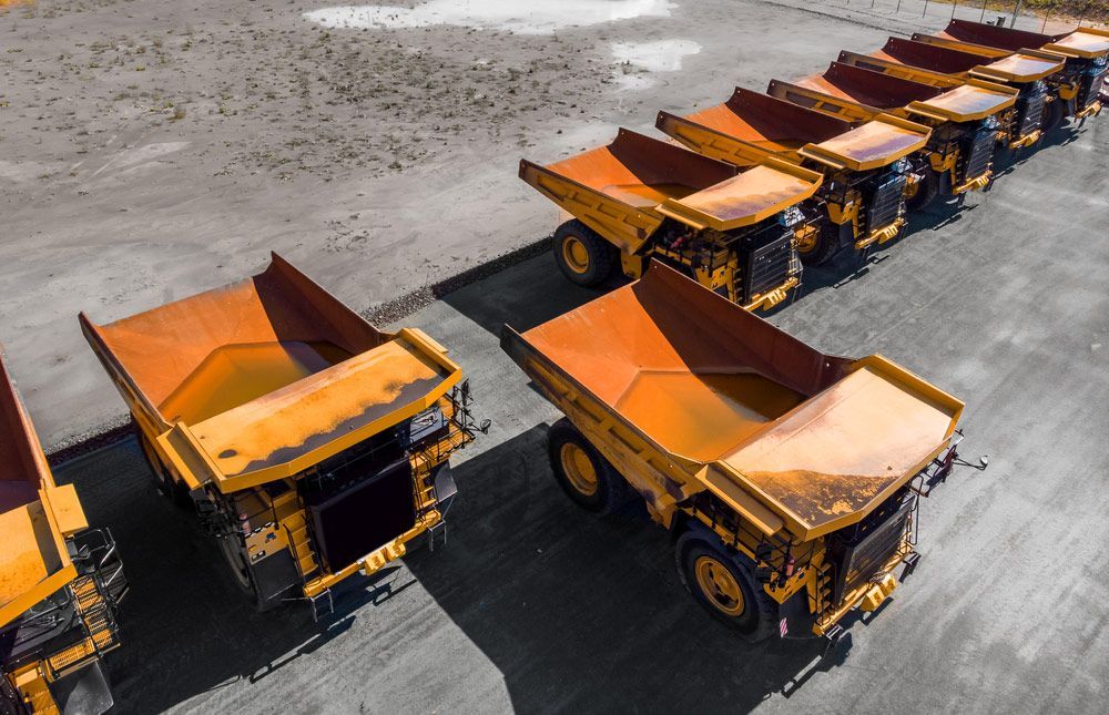 Row of Dump Trucks Are Parked in a Parking Lot — Barkly Hire in Ryan, QLD