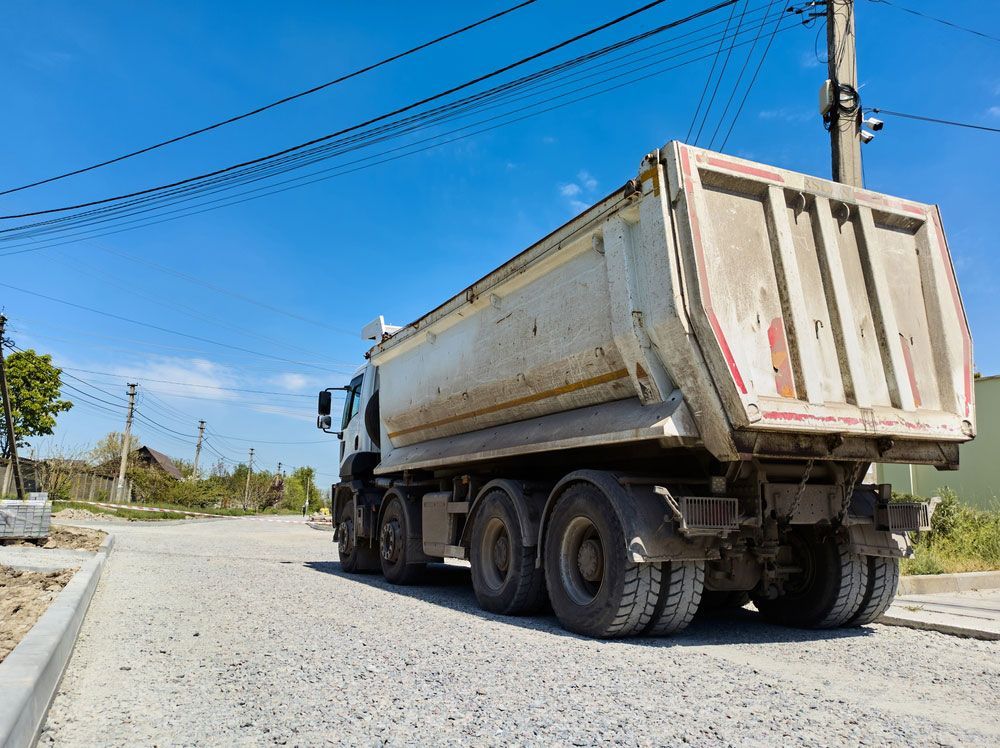 Dump Truck is Driving Down a Gravel Road — Barkly Hire in Ryan, QLD