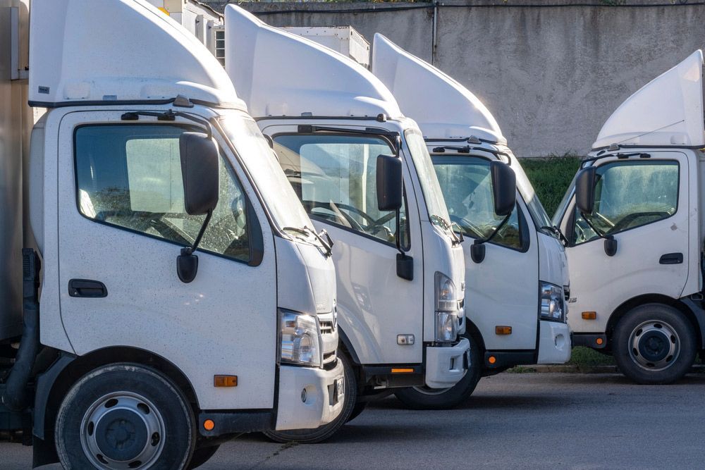 Row of White Trucks Parked Next to Each Other in a Parking Lot — Barkly Hire in Ryan, QLD