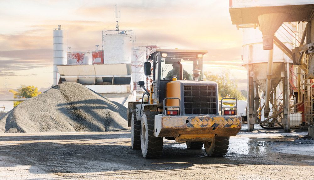 Bulldozer is Driving Down a Dirt Road in a Construction Site — Barkly Hire in Ryan, QLD