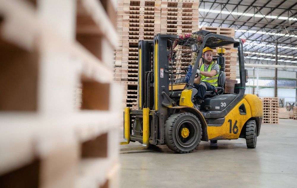 Man is Driving a Forklift in a Warehouse — Barkly Hire in Ryan, QLD