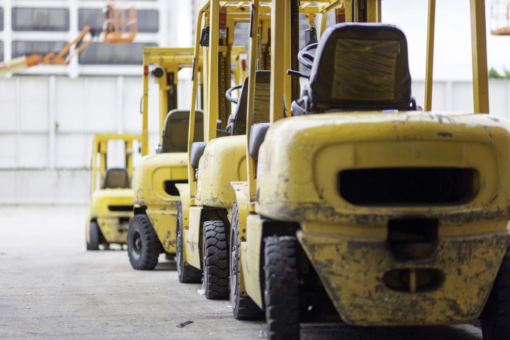 Row of Yellow Forklifts Are Parked in a Warehouse — Barkly Hire in Ryan, QLD