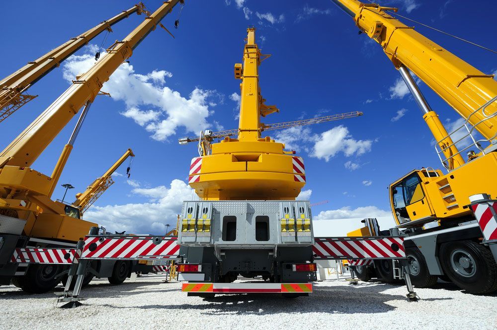Large Yellow Crane is Sitting on Top of a Truck in a Parking Lot — Barkly Hire in Ryan, QLD