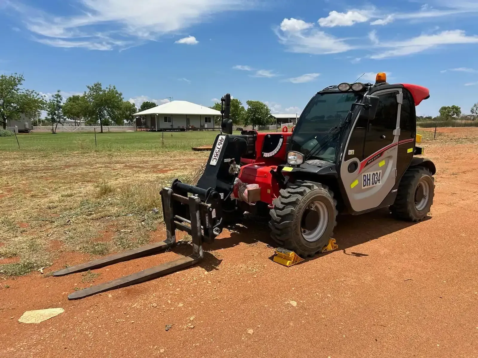 Compact utility vehicle with front attachment on a dirt path — Barkly Hire in Karumba, QLD