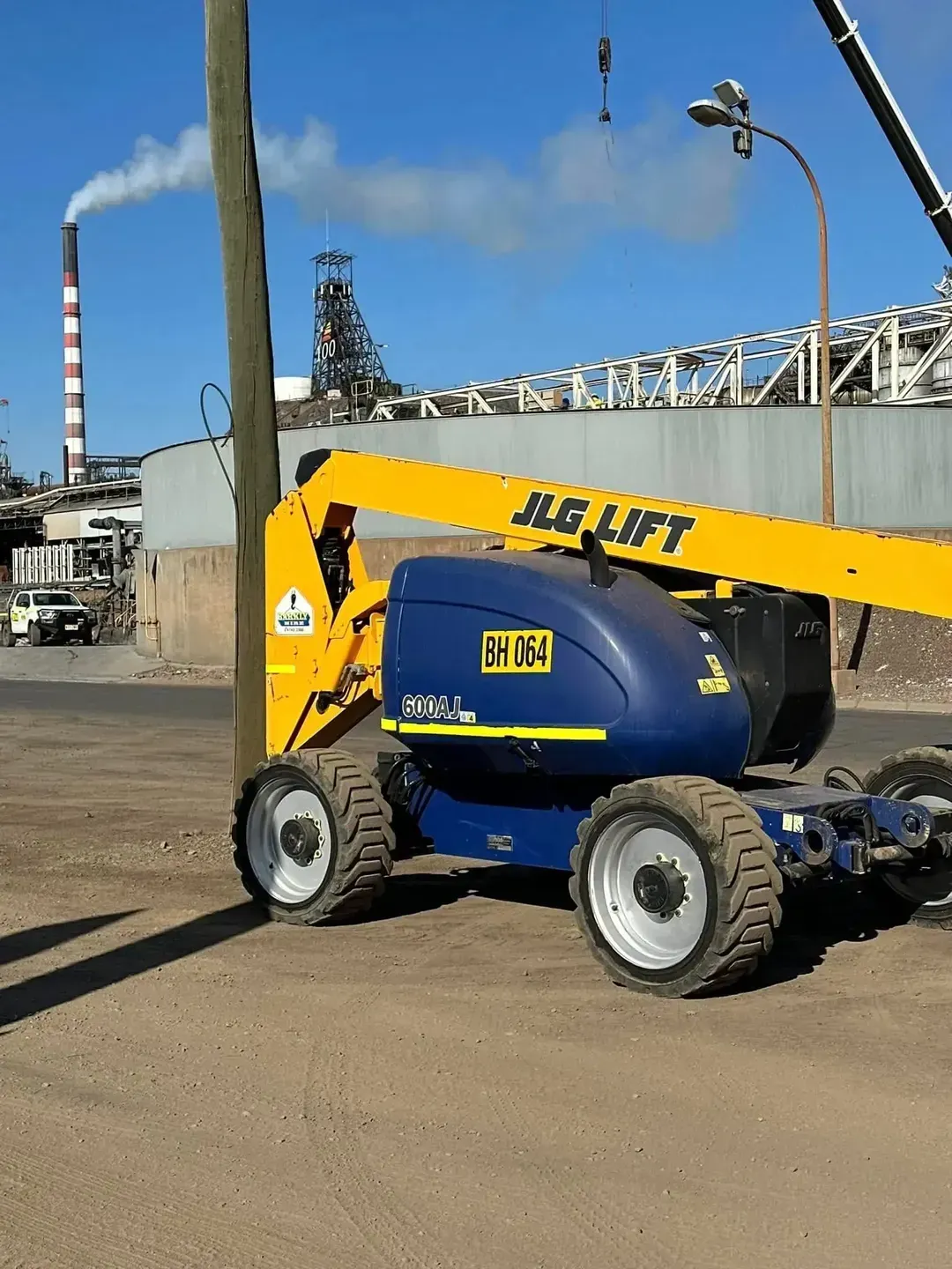Yellow and blue boom lift parked on a construction site — Barkly Hire in Cloncurry, QLD