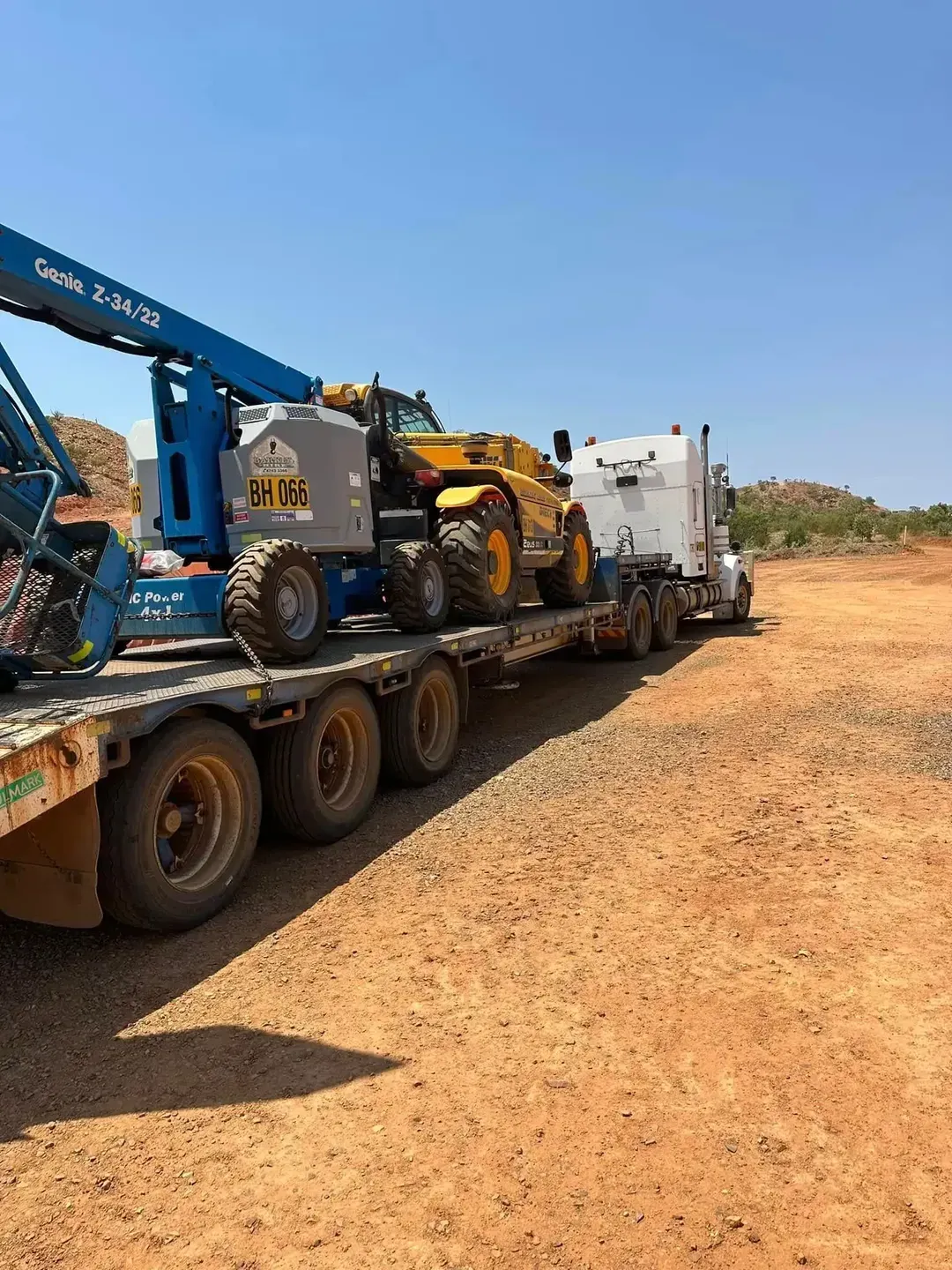 Heavy equipment loaded on a flatbed truck — Barkly Hire in Cloncurry, QLD