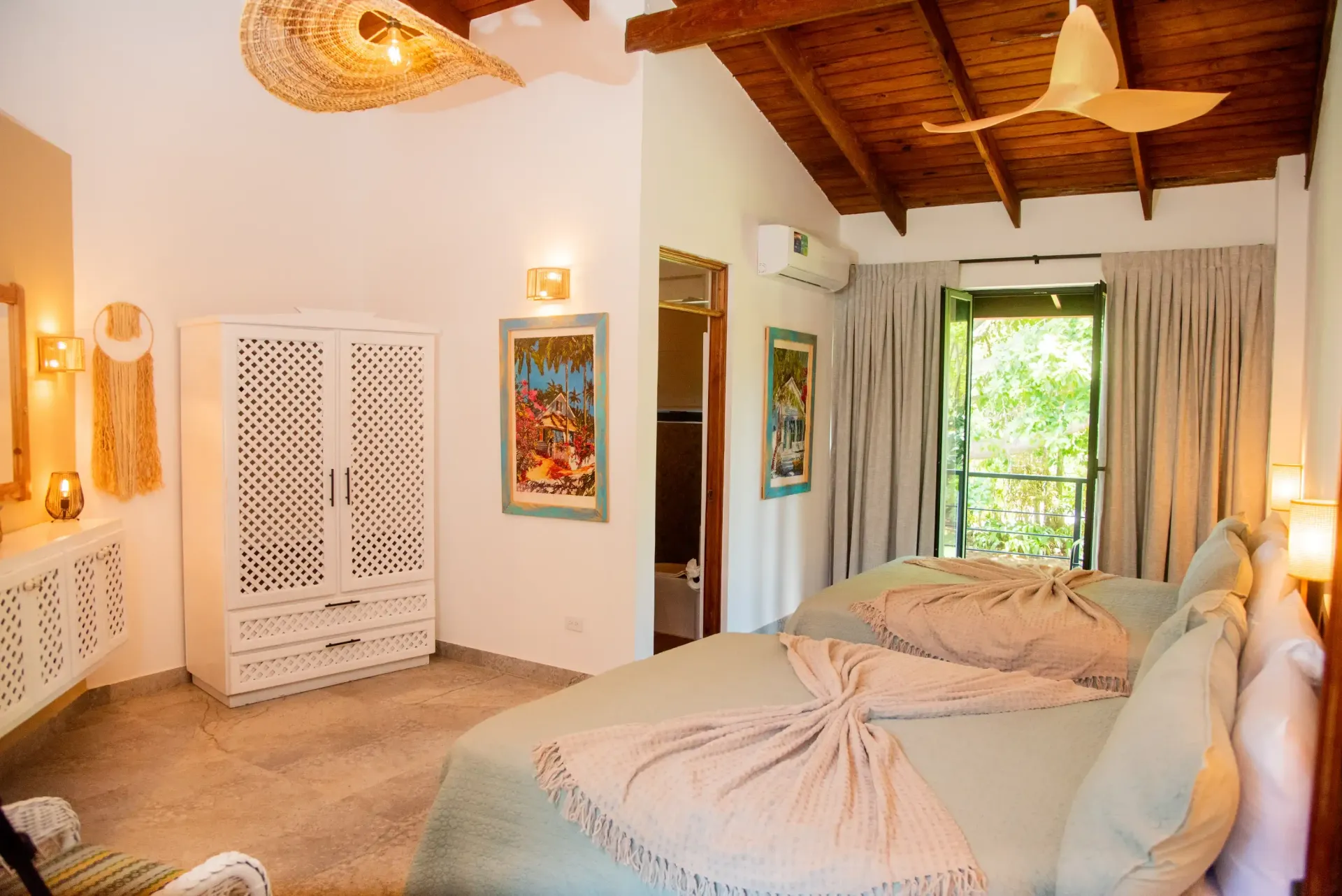 A bedroom with two beds and a ceiling fan.