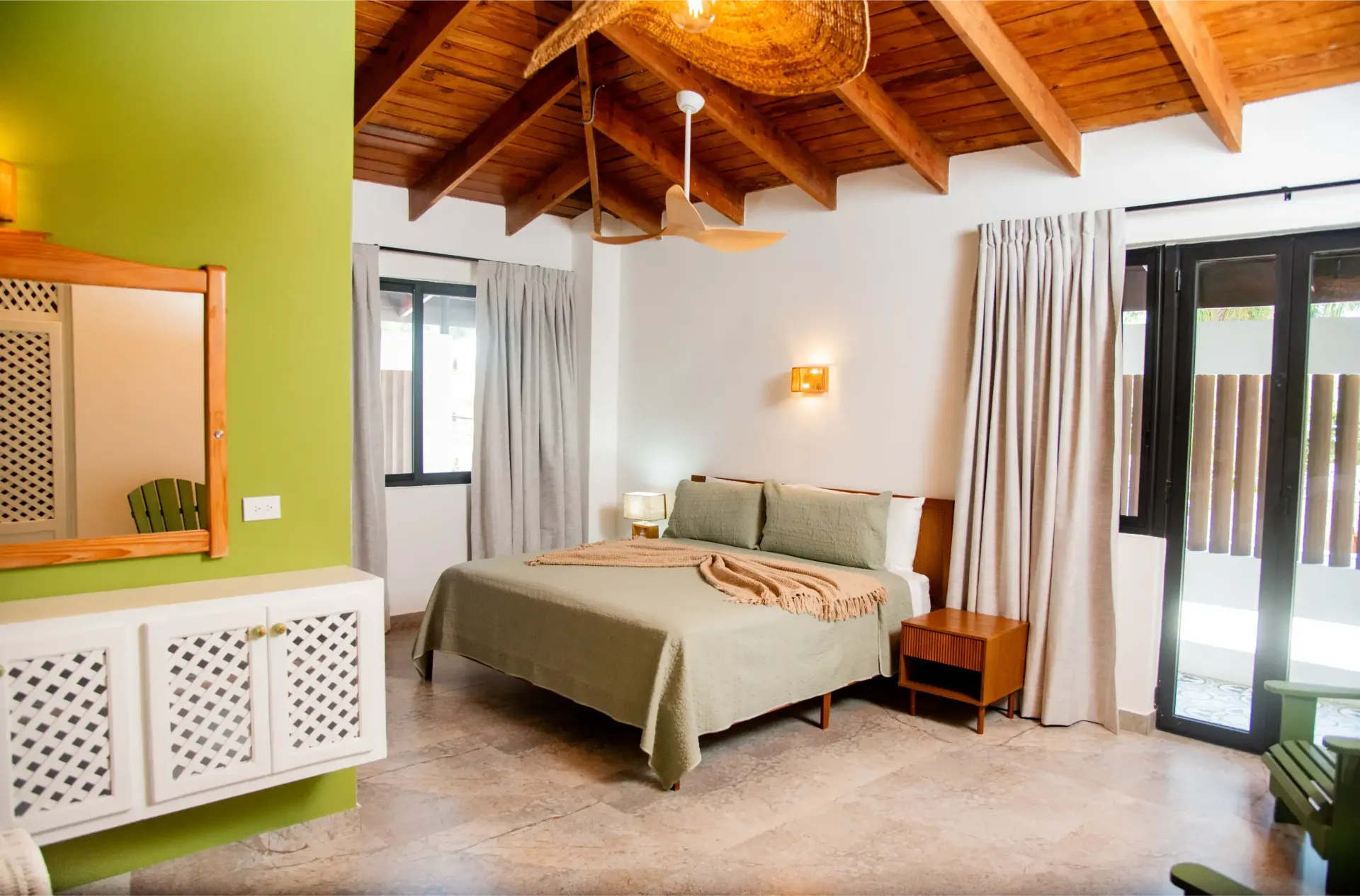 A bedroom with a large bed and a mirror