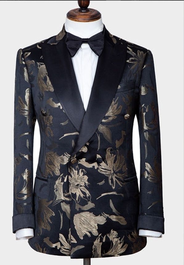 A black and gold tuxedo jacket with a bow tie on a mannequin.