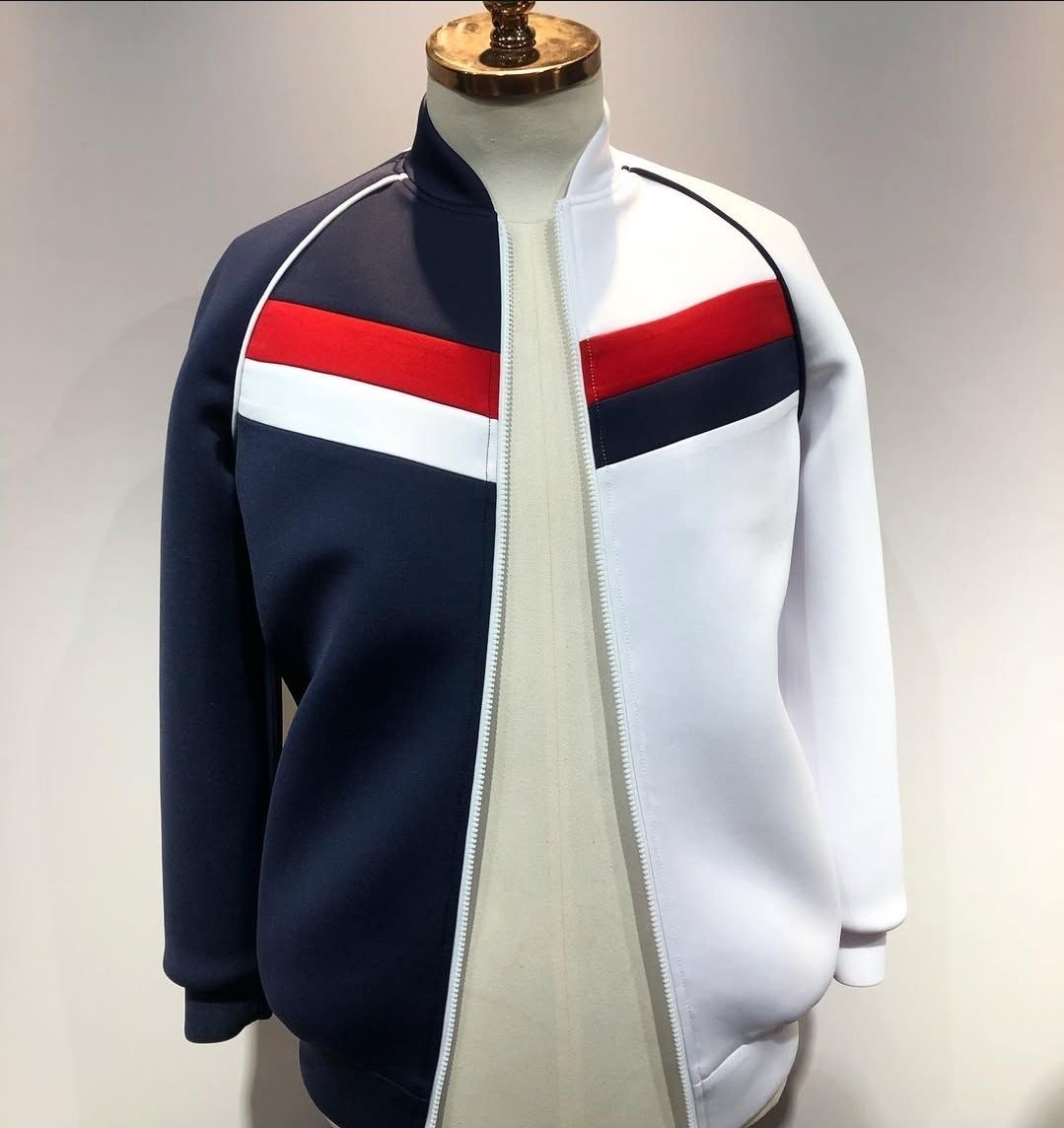 A blue white and red jacket is on a mannequin
