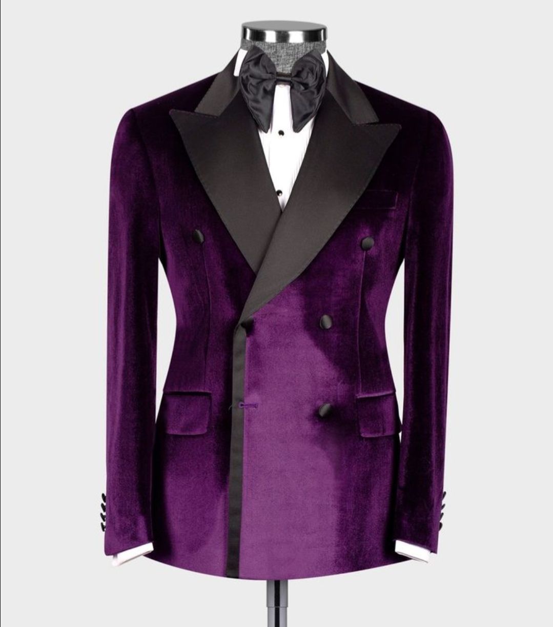 A mannequin wearing a purple tuxedo and bow tie