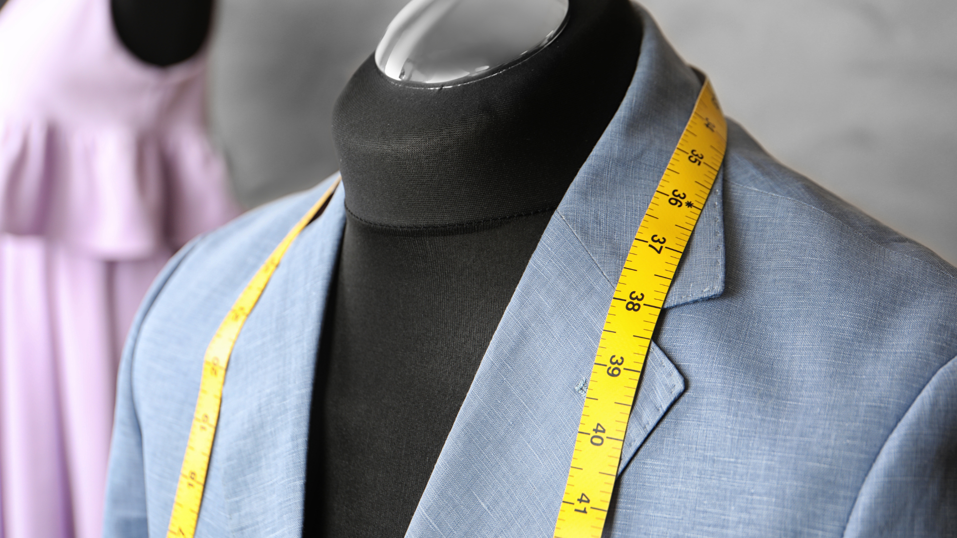 A blue jacket with a yellow measuring tape around it.