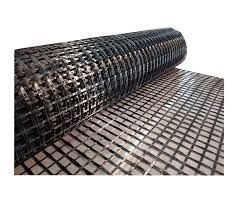 Rolled black wire mesh on a flat surface, showing a square grid pattern.