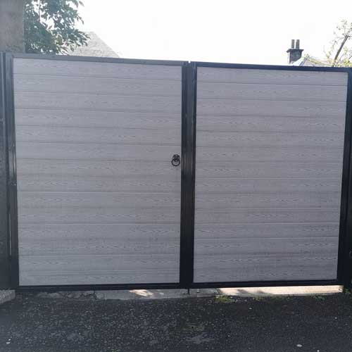 White gates with black details and lock