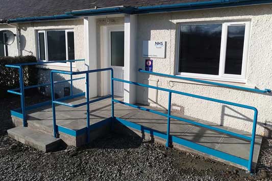 NHS building with entrance ramp and blue railings