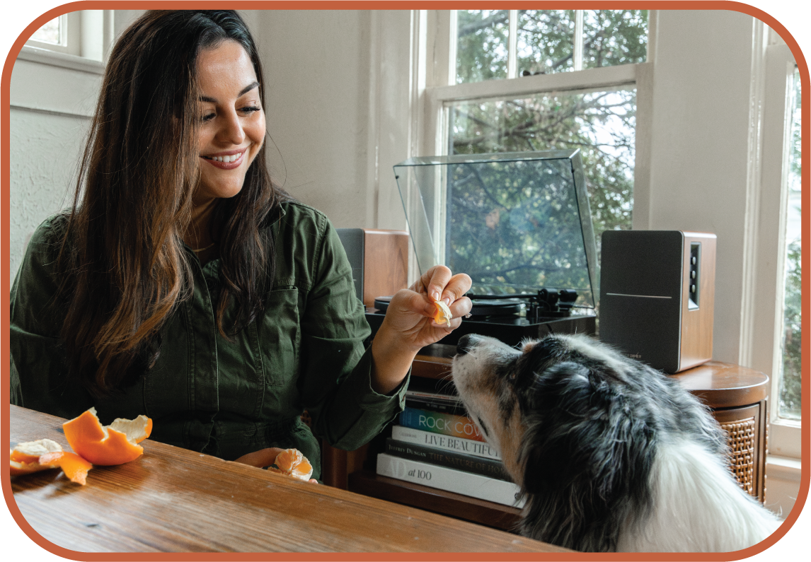 ADHD therapist Alexis Saville enjoying downtime with her dog, sharing an orange